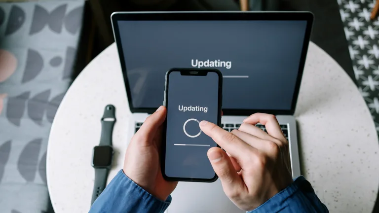 Person updating their phone and laptop