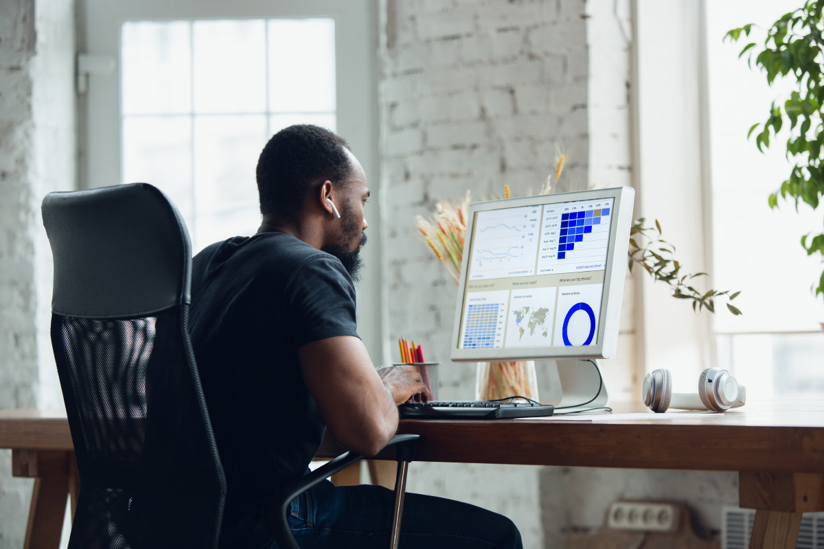 Man looking at charts on cumputer at home office