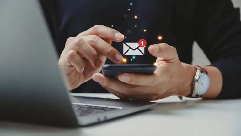 Hand of businessman using smartphone for email with notification alert.