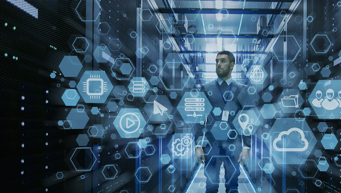 Man in server room surrounded by web icons
