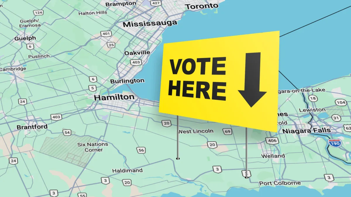 Map of southern Ontario focusing on Hamilton in the center, with a vote here sign coming out fo the map